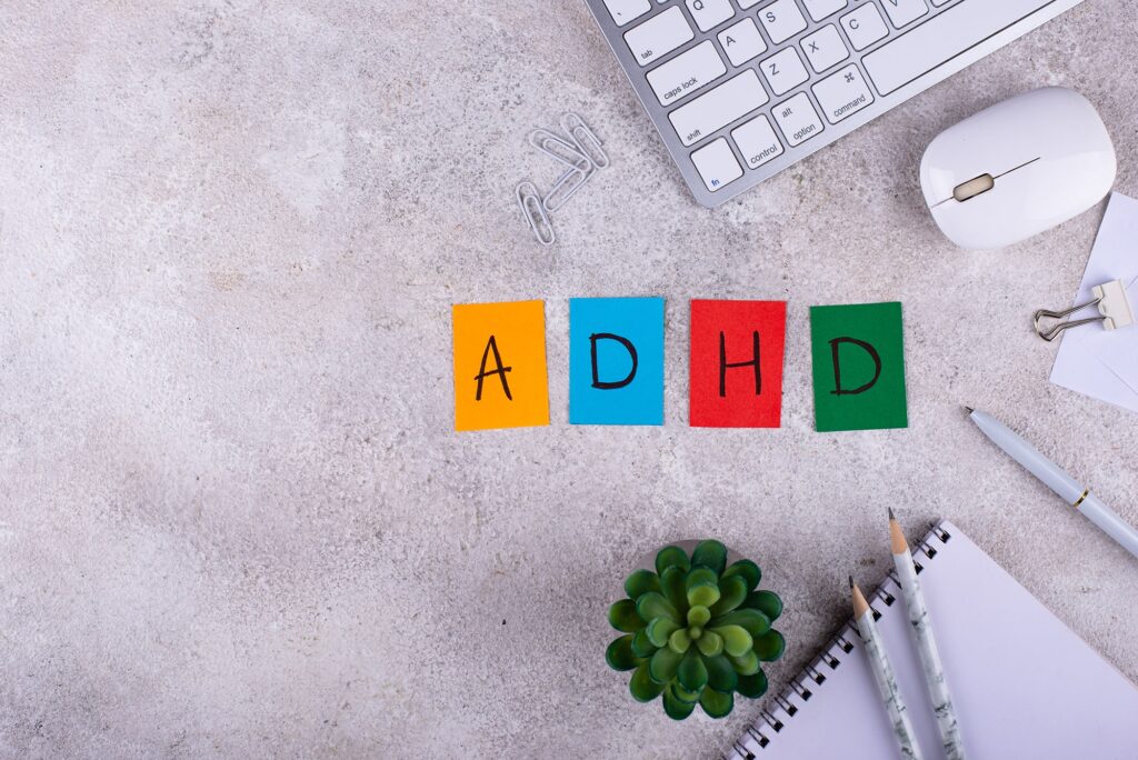 Computer keyboard and mouse with the block letters ADHD