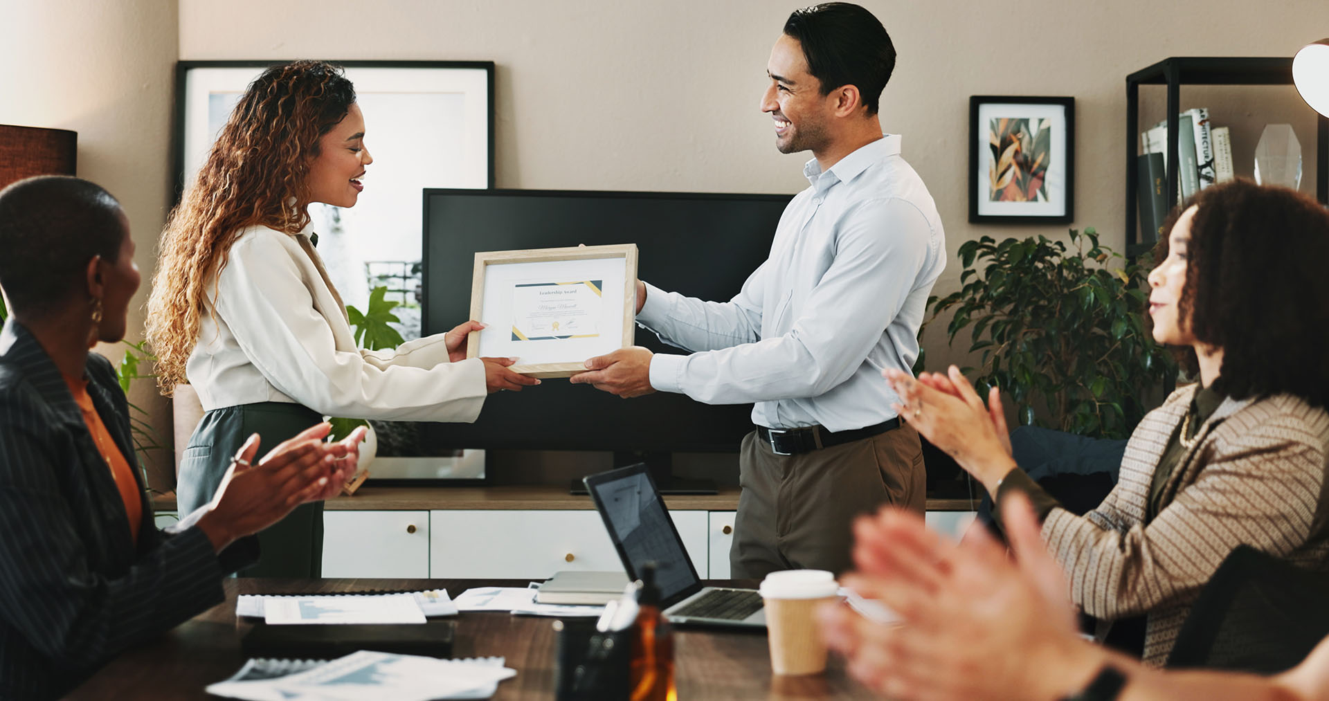 Man handing a woman it certificate